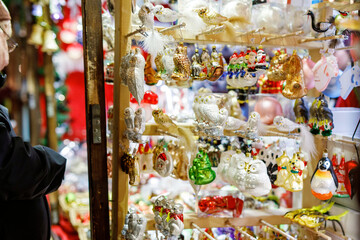 Colorful close up details of christmas fair market. Balls decorations for sales. Xmas market in...