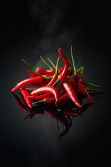 Red hot chili pepper on a black background.