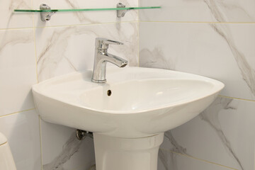 Washbasin in the bathroom and faucet with cold and hot water