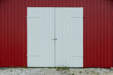 Red door and exterior clapboard wall - stock photo