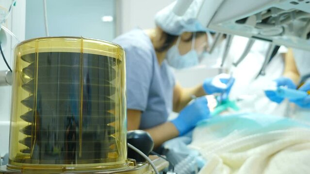 Mechanical ventilation and life saving while dental surdery. Movement of lungmotor. team of dental surgeons performing invasive operations with general anesthesia. 4 k video
