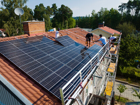 Installation of solar panels on roof of house