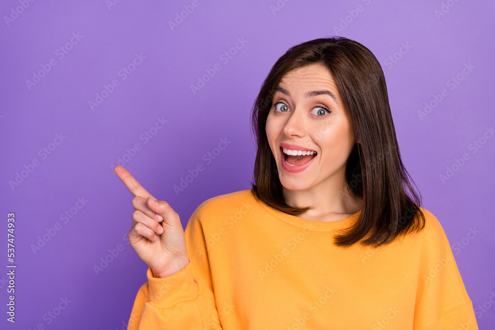 Poster Closeup photo of young woman bob brown hair excited toothy finger point empty space demonstrate ad offer isolated on purple color background