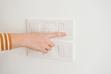 Finger touching switch for blinds on the wall