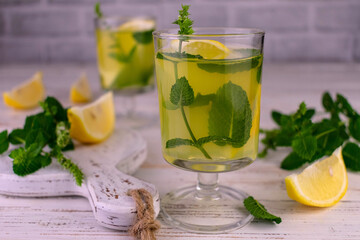 Italian lemon liqueur limoncellos with mint.Close-up.
