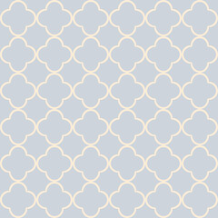 Seamless Moroccan style geometric quatrefoil pattern design in pastel yellow color on pastel blue background