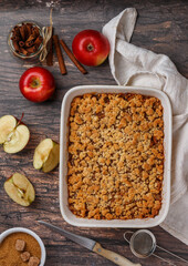 Apple crumble. Homemade pie of fresh apples with caramel and cinnamon. Delicious autumn pastries. healthy dessert. Breakfast. Wooden background. Rustic style. Selective focus, top view and copy space