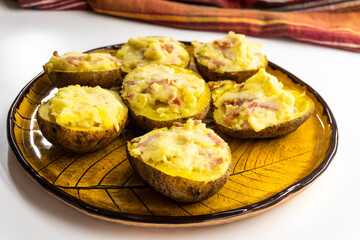 Stuffed potatoes on a yellow plate. food concept