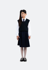 Junior school elementary girl in student uniform standing and looking camera on white background.
