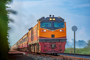 Obraz premium Passenger train by diesel locomotive on the railway.