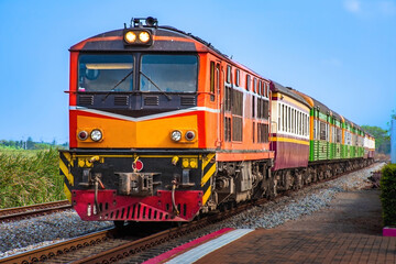 Naklejka premium Passenger train by diesel locomotive on the railway.