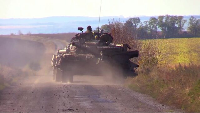 A Ukrainian tank drives along the road between the fields. Counteroffensive of the Ukrainian army. Real War 2022. Russia attacked Ukraine. Ukraine defends its independence and liberates territories