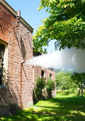 Steam whistle in a brick wall