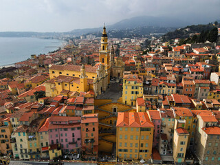 Obraz premium Aerial view of Menton in French Riviera from above. Drone view of France Cote d'Azur sand beach beneath the colorful old town of Menton. Small color houses near the border with Italy, Europe.