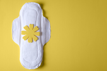 Female hygienic urological pad for urinary incontinence with a sad smiley on a yellow background