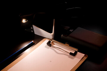 illuminated notepad with mobile and power bank on the desk, energy poverty concept power outages