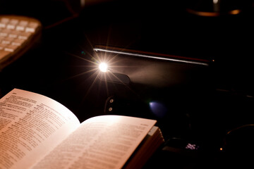 cell phone and power bank on the desk illuminates reading and study book with battery-powered...