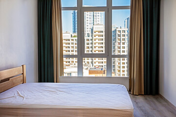 view of skyscrapers from a panoramic window in a stylish interior, horizontal.