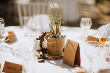 wedding decoration table with glasses in brown and white colors