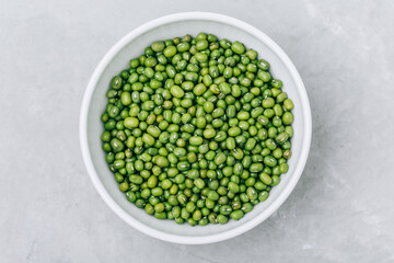 Green Gram. Organic Mung Beans in bowl on gray stone background.