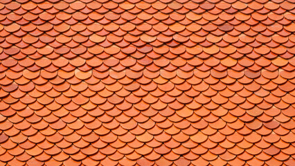 Background and texture of orange imbrication clay tiles roof of Thai temple