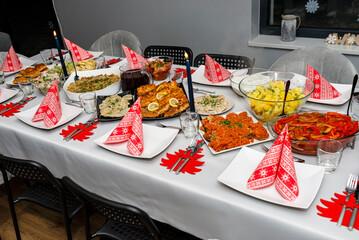 A table set before Christmas dinner with many traditional Polish dishes.