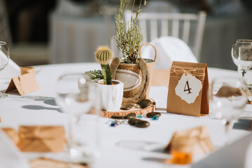 Wedding decoration table in brown and white colors with wood and glass