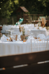 Wedding decoration table in brown and white colors with wood and glass