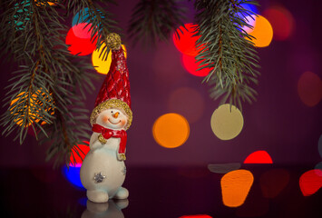 Happy snowman toy sparkling and fabulous bokeh background with copy space. Christmas background for postcards. Christmas decoration concept.