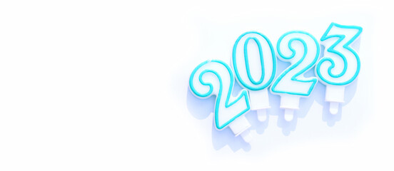 Numeral 2023 on a white background, a banner for a website with a place for your text. Candles in the form of numbers. New Year