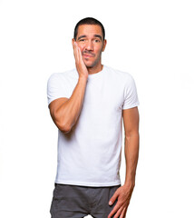 Fototapeta premium Concerned young man doing a gesture of relief