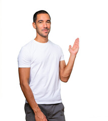 Naklejka premium Friendly young man making a gesture of welcome
