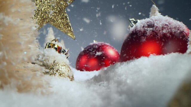 Super slow motion of falling snow with Christmas glass balls. Camera movement on slider. Filmed on high speed cinema camera, 800 fps.