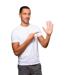 Young man pointing to his wrist