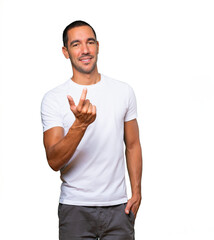 Happy young man doing a welcome gesture with his hand