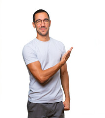 Fototapeta premium Friendly young man making a gesture of welcome