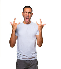 Fototapeta premium Naughty young man making a rock gesture