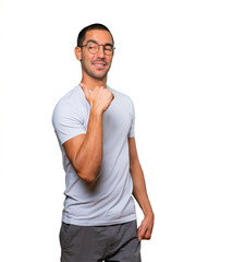 Fototapeta premium Happy young man pointing with his thumb