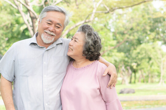 elderly healthy asian couple smile and relax in the park together