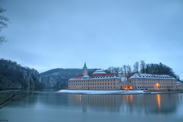 Weltenburg Abbey with a reflection on the Danube River at winter, Bavaria, Weltenburg, Germany