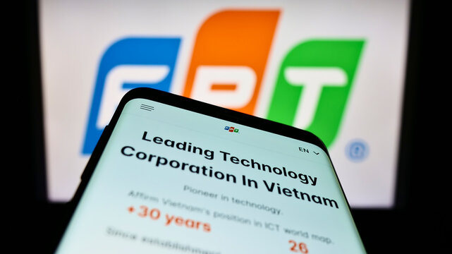 Stuttgart, Germany - 10-01-2022: Mobile phone with webpage of Vietnamese IT company FPT Corporation on screen in front of business logo. Focus on top-left of phone display.