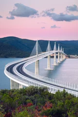 Wandcirkels aluminium Peljesac Bridge, Croatia. Image of beautiful modern multi-span cable-stayed Peljesac Bridge over the sea in Dubrovnik-Neretva County, Croatia at sunrise. © rudi1976