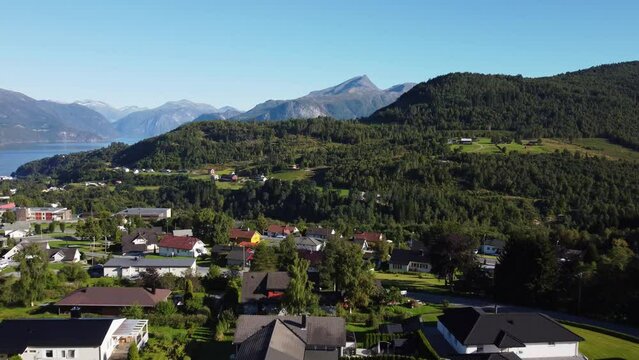 Drone view of the Stranda village surrounded by forests and mountains in Norway