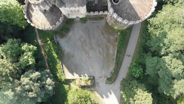 Tourists visiting Butron medieval castle in Gatika at sunrise, Spain. Aerial 4K