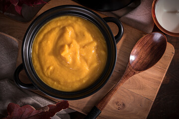 creamy pumpkin soup in a black pot