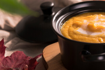 creamy pumpkin soup in a black pot