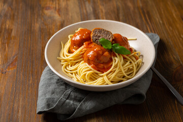 Close up of spaghetti pasta with meatball on wooden surface food