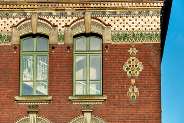red brick and art deco tiled decoration on the facade of Lamartine middle school in Dunkirk, france