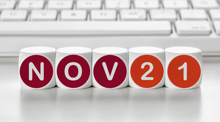 Letter dice in front of a keyboard - November 21