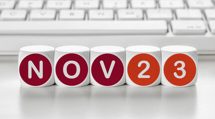Letter dice in front of a keyboard - November 23